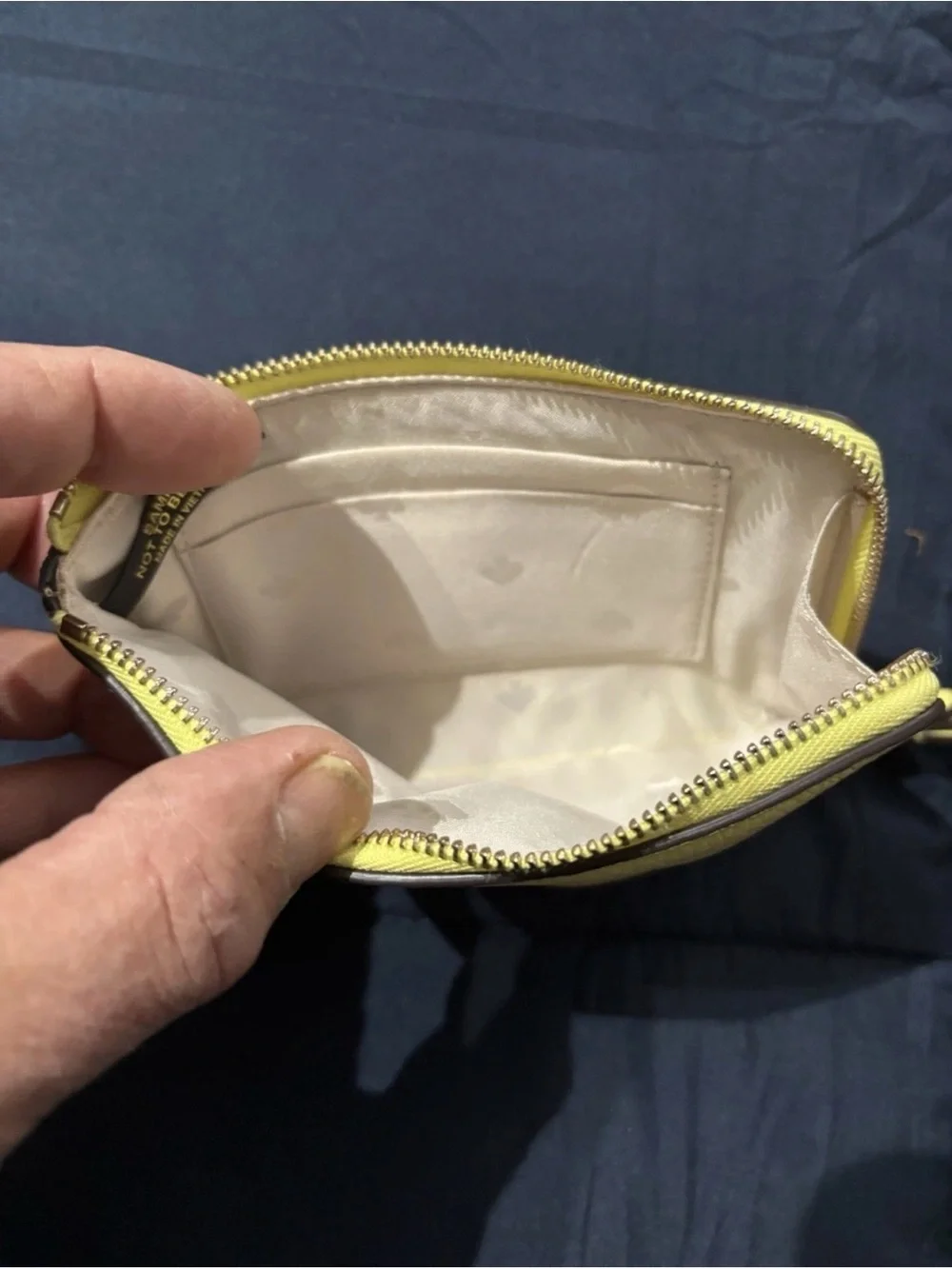 kate spade pale yellow pebbled leather wristlet with striped strap